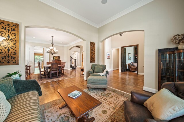 77 Big Trl, Missouri City, TX 77459 - living area featuring arched walkways, a chandelier, wood finished floors, baseboards, and stairway