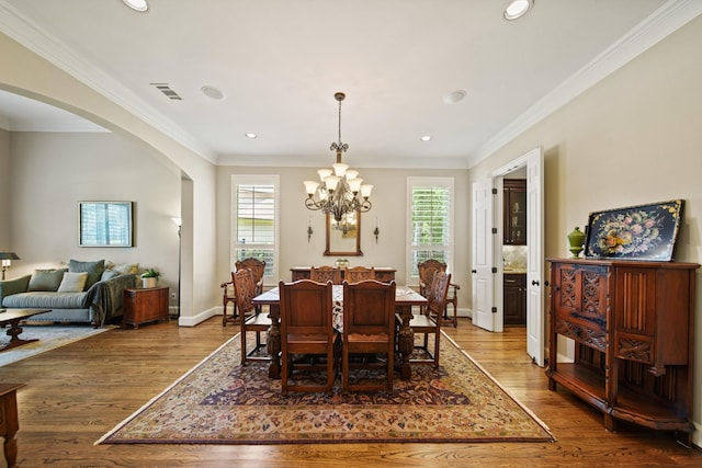 77 Big Trl, Missouri City, TX 77459 - dining room featuring arched walkways, healthy amount of natural light, wood finished floors, ornamental molding, and recessed lighting