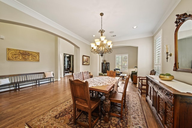 77 Big Trl, Missouri City, TX 77459 - dining area featuring arched walkways, a chandelier, dark wood finished floors, crown molding, and recessed lighting