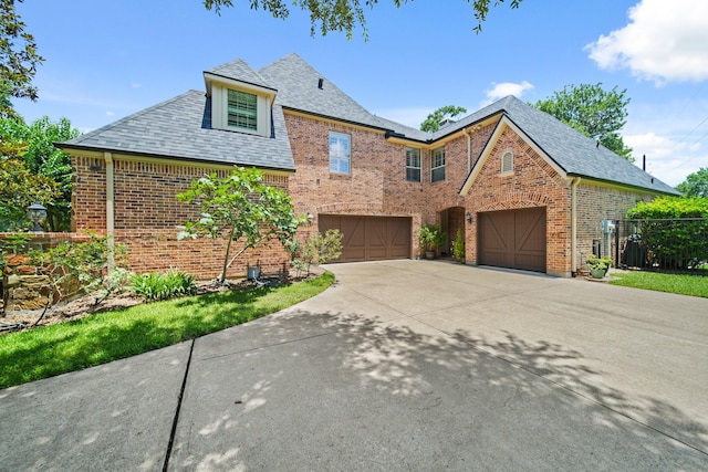 77 Big Trl, Missouri City, TX 77459 - view of front of house with brick siding, an attached garage, driveway, and a shingled roof