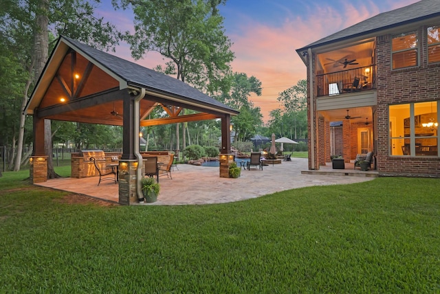 77 Big Trl, Missouri City, TX 77459 - patio terrace at dusk with a gazebo, ceiling fan, and a lawn