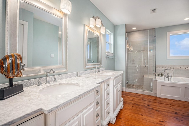 1401 103rd St, Galveston, TX 77554 - full bath with double vanity, a shower stall, a garden tub, hardwood / wood-style flooring, and recessed lighting