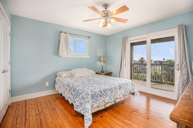 1401 103rd St, Galveston, TX 77554 - bedroom featuring access to exterior, baseboards, multiple windows, and hardwood / wood-style flooring