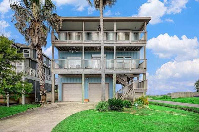 1401 103rd St, Galveston, TX 77554 - view of front of home with board and batten siding, a balcony, concrete driveway, and a garage