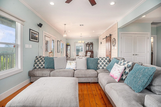 1401 103rd St, Galveston, TX 77554 - living room featuring a barn door, plenty of natural light, recessed lighting, ornamental molding, and ceiling fan