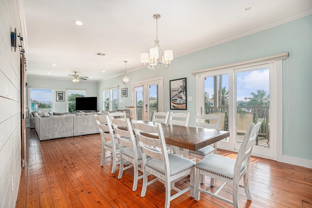 1401 103rd St, Galveston, TX 77554 - dining space with healthy amount of natural light, light wood finished floors, a chandelier, recessed lighting, and crown molding