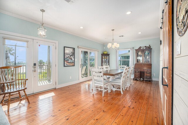 1401 103rd St, Galveston, TX 77554 - dining space with a chandelier, french doors, light wood-style flooring, baseboards, and ornamental molding
