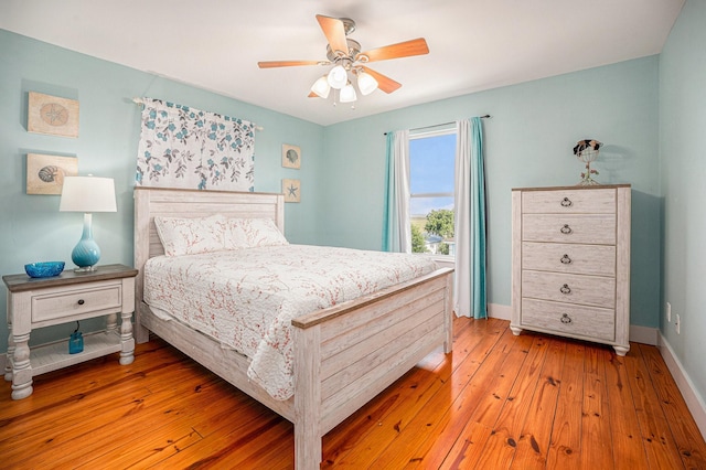 1401 103rd St, Galveston, TX 77554 - bedroom with light wood finished floors, ceiling fan, and baseboards