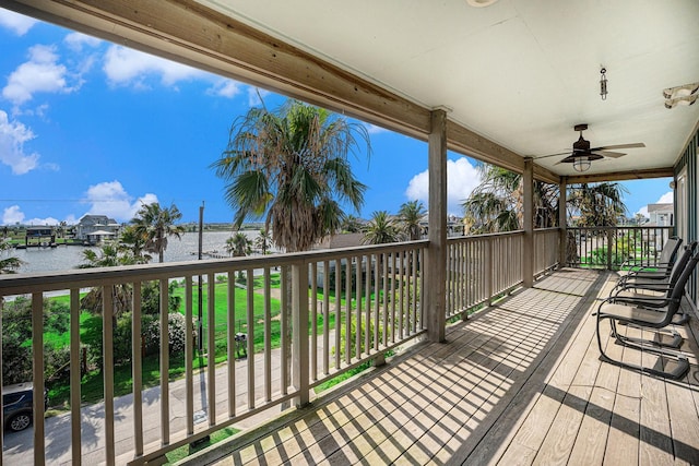 1401 103rd St, Galveston, TX 77554 - wooden deck with a water view and ceiling fan