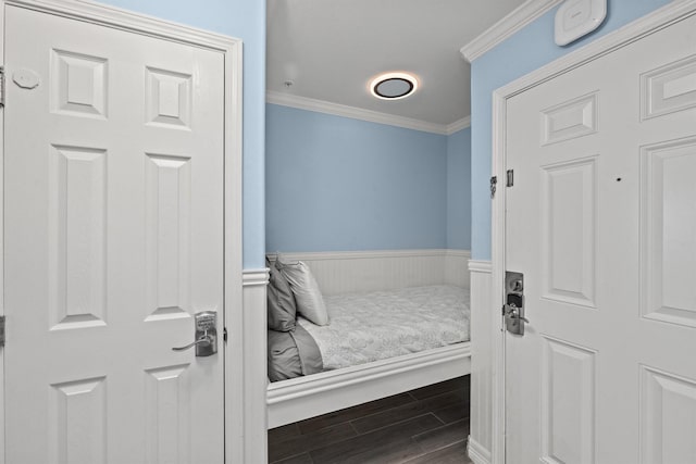 9520 Seawall Blvd Unit 338, Galveston, TX 77554 - bedroom with ornamental molding, wood finished floors, and a wainscoted wall