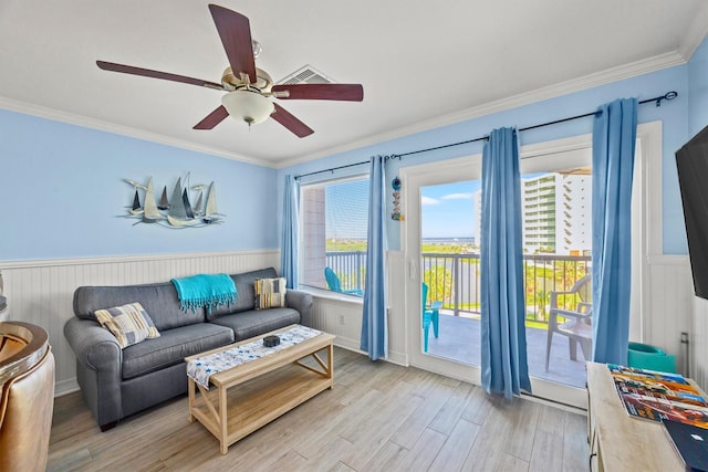 9520 Seawall Blvd Unit 338, Galveston, TX 77554 - living room with a wainscoted wall, light wood finished floors, crown molding, and a ceiling fan