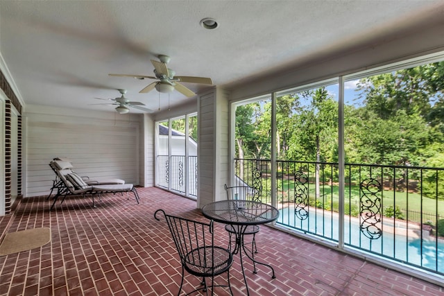 74 Grogans Point Rd, The Woodlands, TX 77380 - sunroom featuring a ceiling fan and view of wooded area