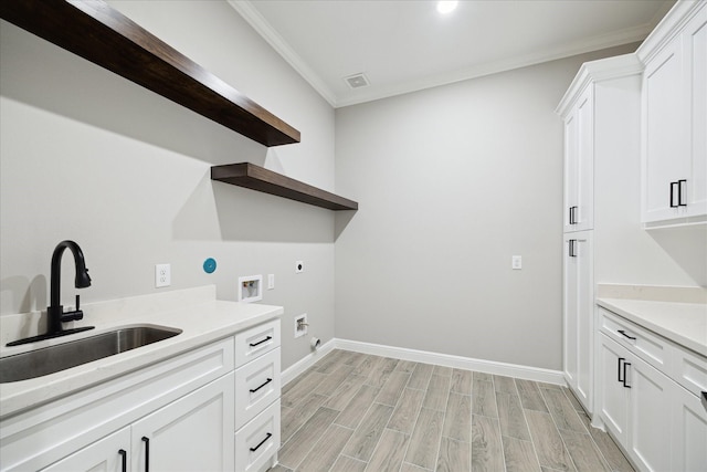 26800 Saddle Horn, Waller, TX 77484 - washroom with hookup for an electric dryer, washer hookup, cabinet space, light wood-style flooring, and crown molding