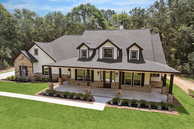 26800 Saddle Horn, Waller, TX 77484 - view of front of home with stone siding, a shingled roof, board and batten siding, and a chimney
