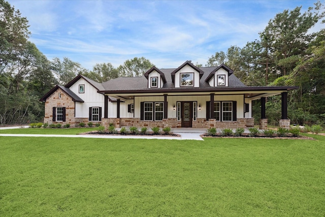 26800 Saddle Horn, Waller, TX 77484 - view of front of home featuring stone siding, a front lawn, a porch, and board and batten siding
