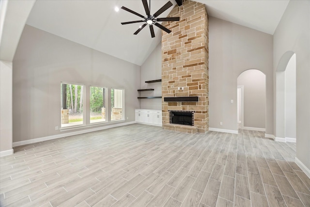 26800 Saddle Horn, Waller, TX 77484 - unfurnished living room with high vaulted ceiling, a ceiling fan, light wood-type flooring, baseboards, and a fireplace