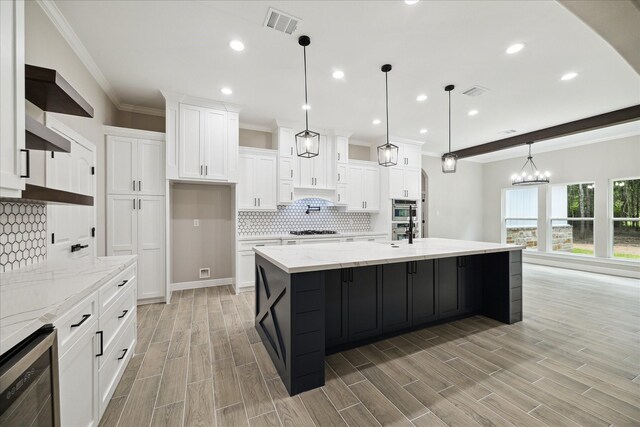 26800 Saddle Horn, Waller, TX 77484 - kitchen featuring beverage cooler, crown molding, gas cooktop, tasteful backsplash, and white cabinetry