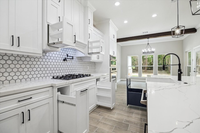 26800 Saddle Horn, Waller, TX 77484 - kitchen featuring appliances with stainless steel finishes, white cabinetry, backsplash, recessed lighting, and decorative light fixtures