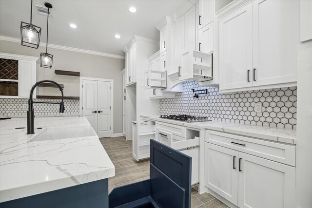 26800 Saddle Horn, Waller, TX 77484 - kitchen featuring ornamental molding, stainless steel gas stovetop, white cabinetry, tasteful backsplash, and recessed lighting
