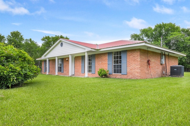2715 Tinkler St, Rock Island, TX 77470 - single story home with cooling unit, a front lawn, covered porch, brick siding, and metal roof