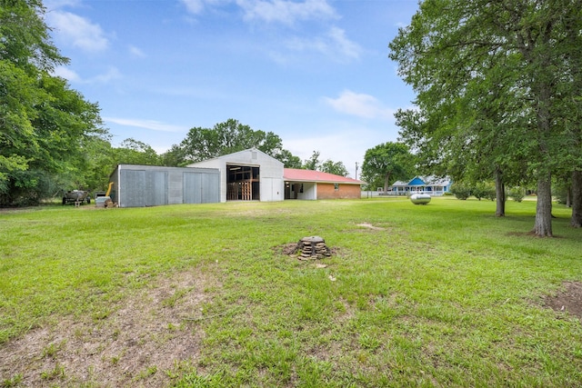 2715 Tinkler St, Rock Island, TX 77470 - view of grassy yard with a pole building and an outbuilding