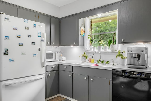 2715 Tinkler St, Rock Island, TX 77470 - kitchen with white appliances, gray cabinets, a sink, and light countertops