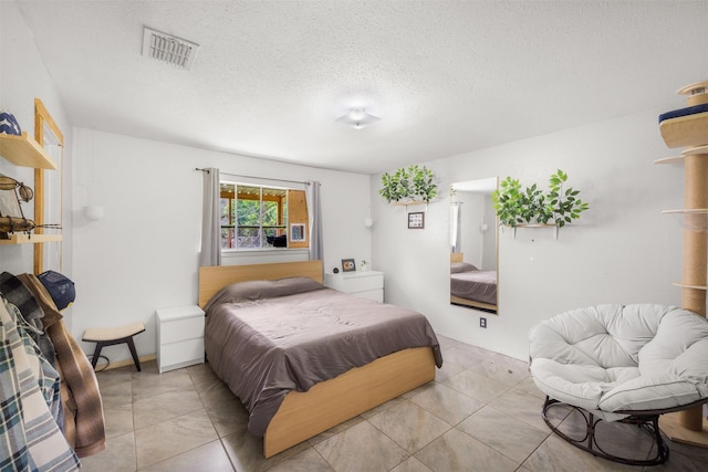 2715 Tinkler St, Rock Island, TX 77470 - tiled bedroom with a textured ceiling