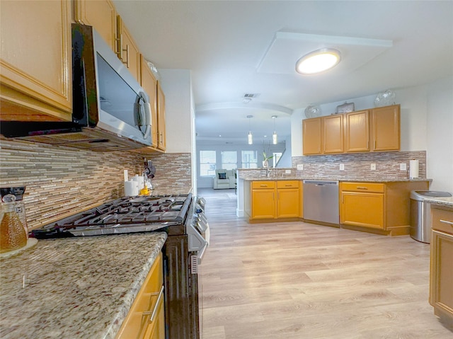 18323 River Sage Dr, Houston, TX 77084 - kitchen with appliances with stainless steel finishes, light wood-type flooring, and light stone counters