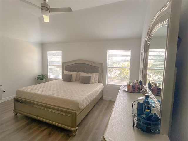 18323 River Sage Dr, Houston, TX 77084 - bedroom featuring vaulted ceiling, wood finished floors, baseboards, and multiple windows