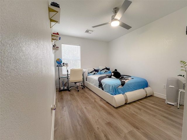 18323 River Sage Dr, Houston, TX 77084 - bedroom with light wood-style floors, a ceiling fan, and baseboards