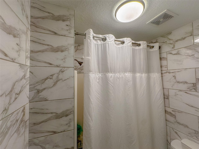18323 River Sage Dr, Houston, TX 77084 - full bathroom featuring a shower with curtain, toilet, and a textured ceiling