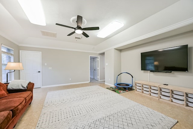 2803 Canyon Dr, Pearland, TX 77584 - living room featuring a tray ceiling, ornamental molding, a ceiling fan, and baseboards