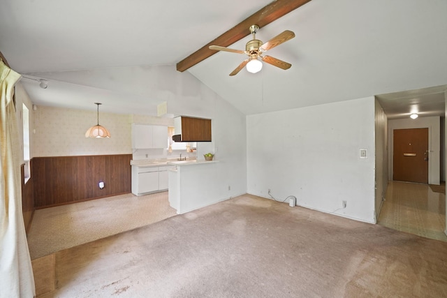 6027 Dellfern Dr, Houston, TX 77035 - unfurnished living room with ceiling fan, a wainscoted wall, wooden walls, and light colored carpet
