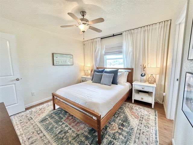 753 Bluewater Hwy, Surfside Beach, TX 77541 - bedroom with wood finished floors, a textured ceiling, a ceiling fan, and baseboards