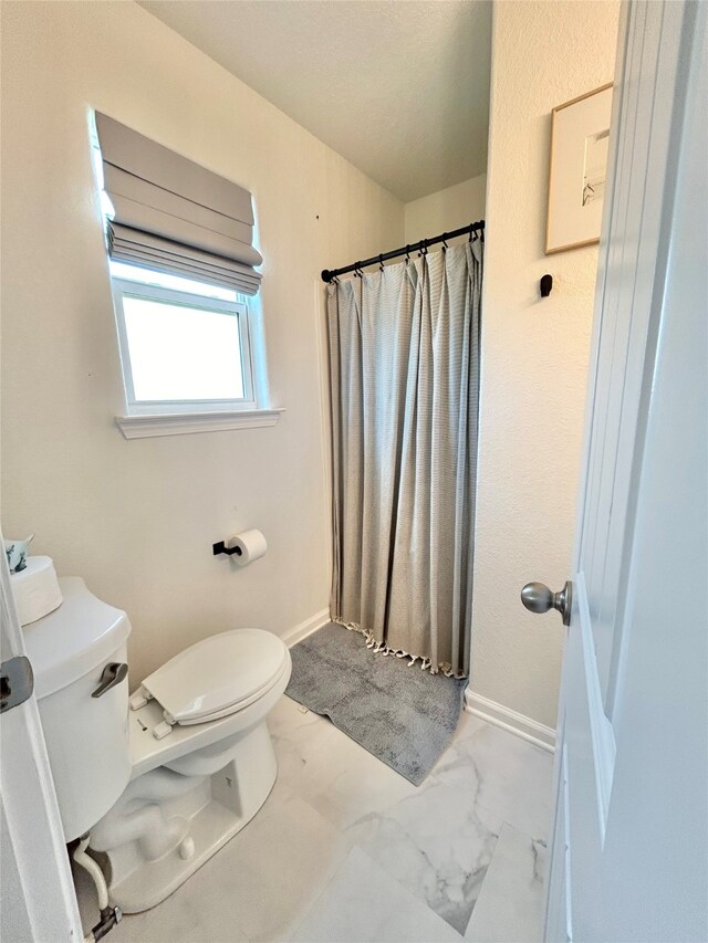753 Bluewater Hwy, Surfside Beach, TX 77541 - bathroom with toilet, marble finish floors, a shower with curtain, and baseboards
