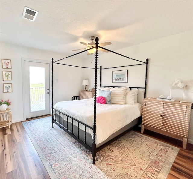 753 Bluewater Hwy, Surfside Beach, TX 77541 - bedroom featuring access to outside, wood finished floors, baseboards, and ceiling fan