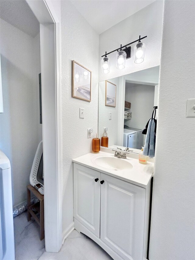 753 Bluewater Hwy, Surfside Beach, TX 77541 - bathroom featuring vanity, a textured wall, and washer / clothes dryer