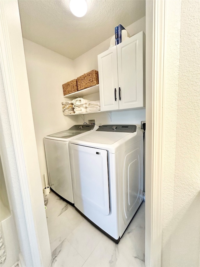 753 Bluewater Hwy, Surfside Beach, TX 77541 - laundry area with cabinet space, separate washer and dryer, light marble finish floors, and a textured ceiling
