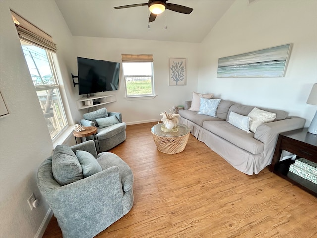 753 Bluewater Hwy, Surfside Beach, TX 77541 - living room with vaulted ceiling, healthy amount of natural light, a ceiling fan, wood finished floors, and baseboards