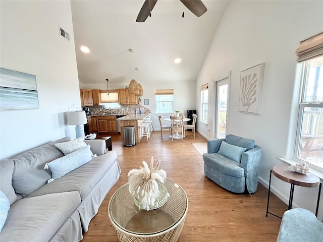 753 Bluewater Hwy, Surfside Beach, TX 77541 - living area with high vaulted ceiling, light wood-style flooring, ceiling fan, healthy amount of natural light, and recessed lighting