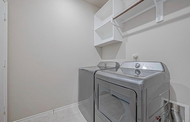 1330 Munson Valley Rd, Richmond, TX 77406 - laundry area featuring washer and clothes dryer, baseboards, and tile patterned flooring