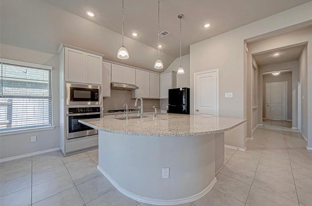 1330 Munson Valley Rd, Richmond, TX 77406 - kitchen featuring stainless steel appliances, under cabinet range hood, white cabinets, a large island, and lofted ceiling