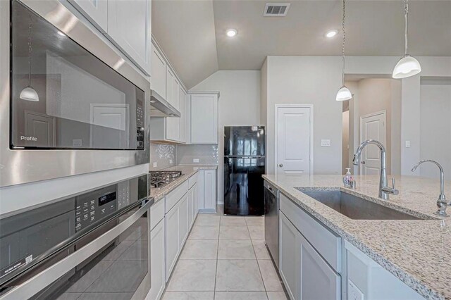 1330 Munson Valley Rd, Richmond, TX 77406 - kitchen featuring stainless steel appliances, a sink, hanging light fixtures, white cabinetry, and lofted ceiling
