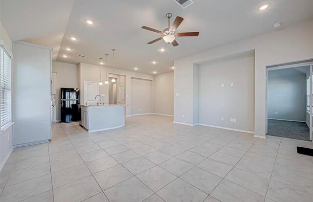 1330 Munson Valley Rd, Richmond, TX 77406 - unfurnished living room featuring ceiling fan, light tile patterned floors, recessed lighting, a sink, and baseboards