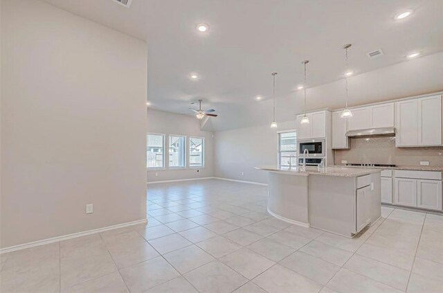 1330 Munson Valley Rd, Richmond, TX 77406 - kitchen featuring under cabinet range hood, light tile patterned flooring, recessed lighting, gas cooktop, and a ceiling fan