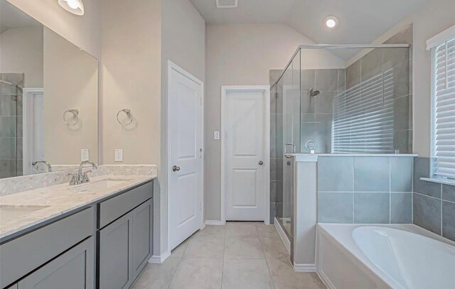 1330 Munson Valley Rd, Richmond, TX 77406 - full bathroom with a shower stall, a garden tub, double vanity, tile patterned flooring, and baseboards