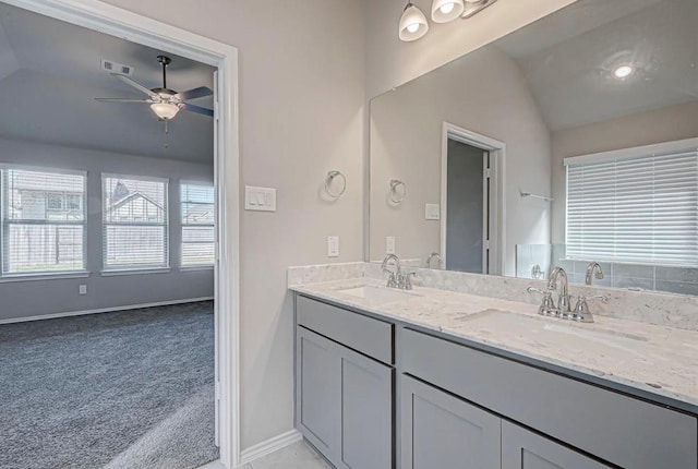 1330 Munson Valley Rd, Richmond, TX 77406 - full bathroom with vaulted ceiling, a ceiling fan, double vanity, and baseboards