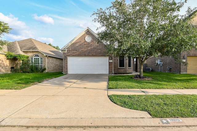 11019 Chestnut Path Way, Tomball, TX 77375 - view of front of house with a garage, brick siding, concrete driveway, a front lawn, and central air condition unit