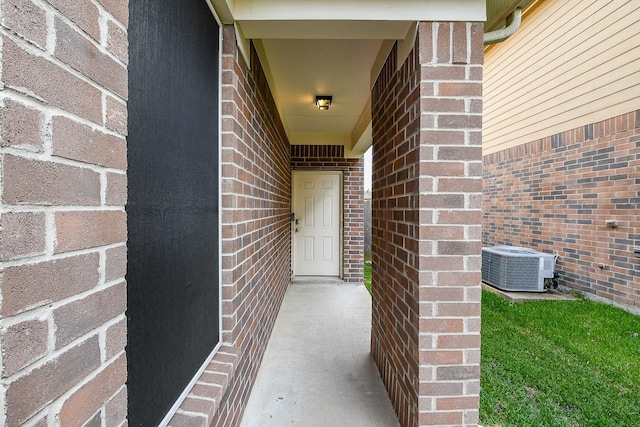 11019 Chestnut Path Way, Tomball, TX 77375 - view of exterior entry featuring central air condition unit and brick siding