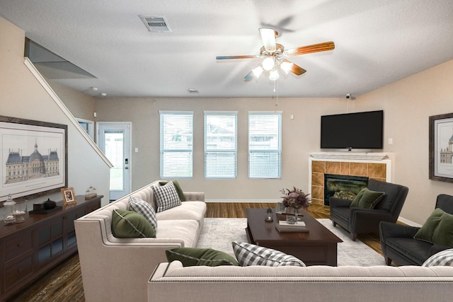 11019 Chestnut Path Way, Tomball, TX 77375 - living area with ceiling fan, dark wood-type flooring, a tiled fireplace, and baseboards